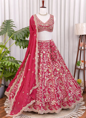 Front view of Rani pink lehenga choli with heavy floral embroidery and detailed traditional design