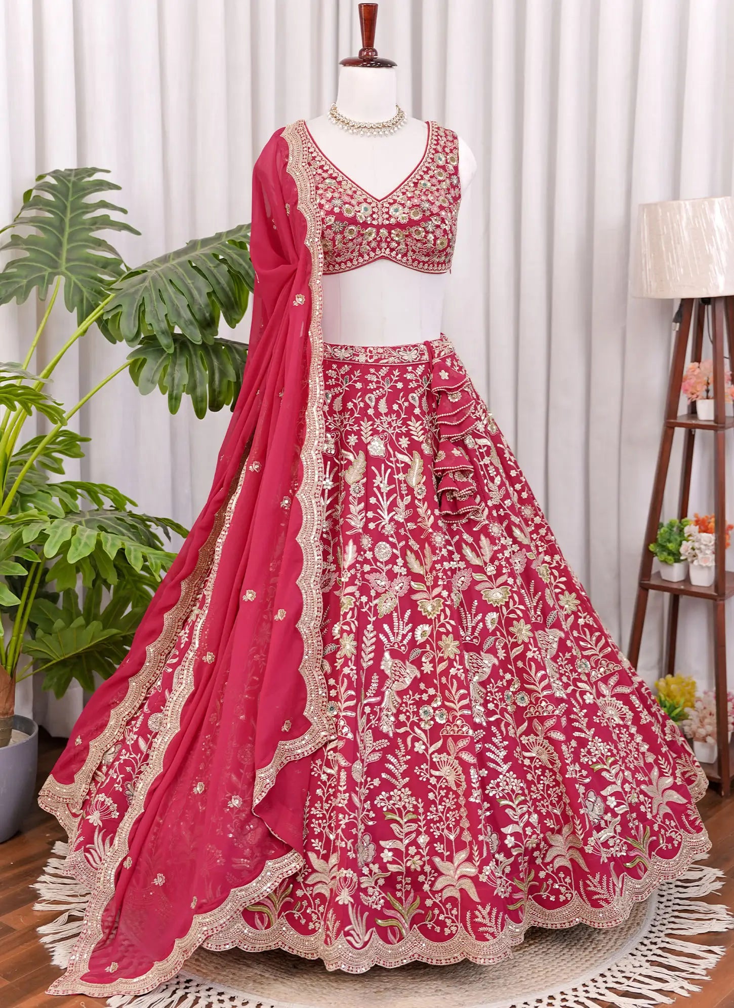 Front view of Rani pink lehenga choli with heavy floral embroidery and detailed traditional design