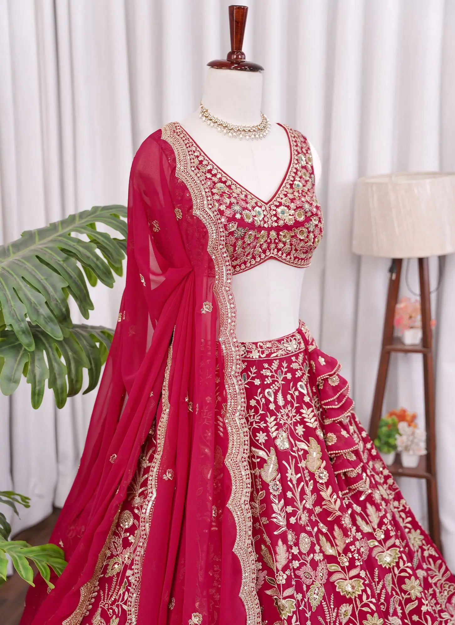 Right side view of Rani pink lehenga choli showcasing heavy floral embroidery design