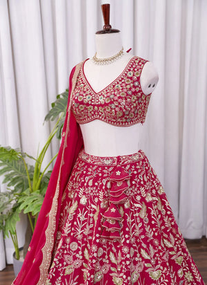 Left side view of Rani pink lehenga choli with intricate heavy floral embroidery work