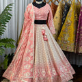 Traditional pink and white embroidered outfit with a matching dupatta
