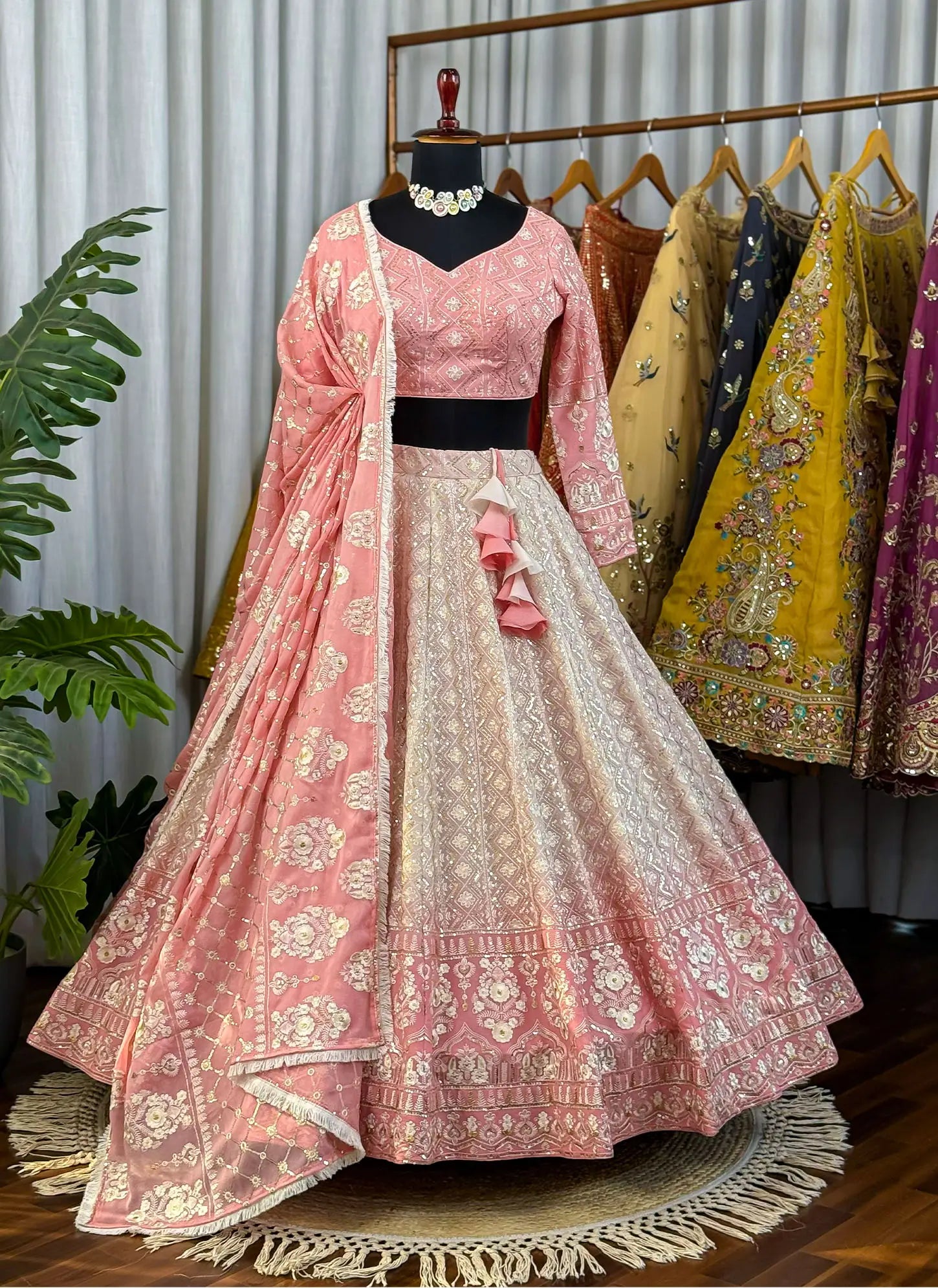 Traditional pink and white embroidered outfit with a matching dupatta