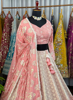 Traditional pink and white embroidered outfit with a matching dupatta