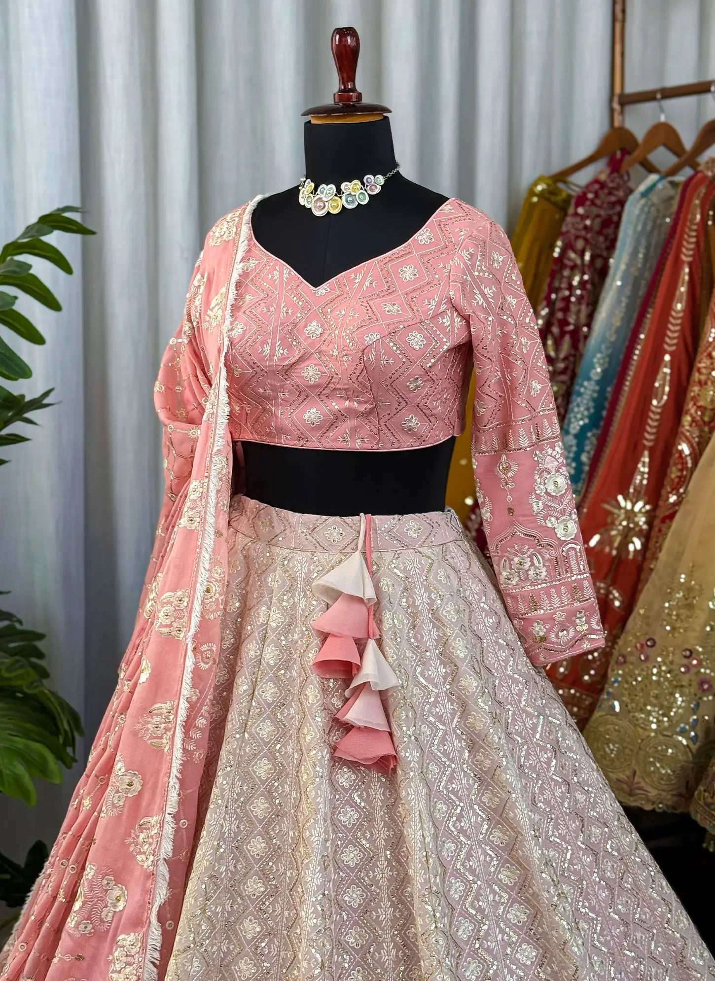 Traditional pink and white embroidered outfit with a matching dupatta