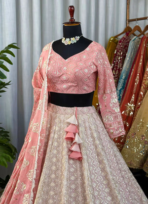 Traditional pink and white embroidered outfit with a matching dupatta